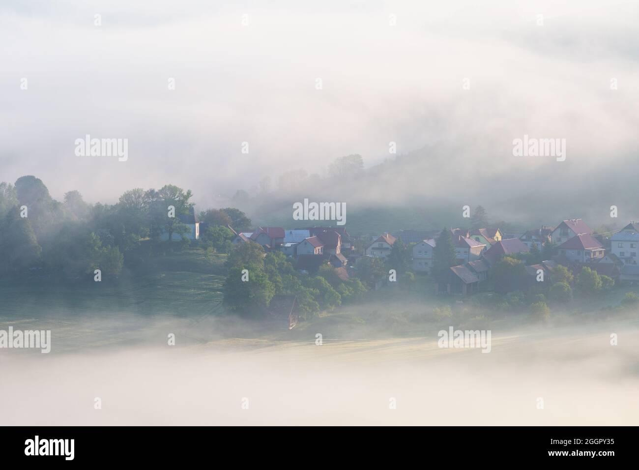 Turcianske Jaseno village shrouded in morning fog, Slovakia. Stock Photo