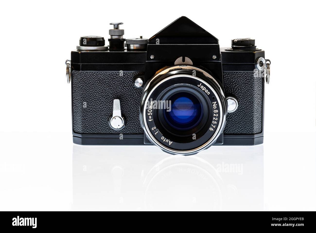 Horizontal shot of a professional 35mm SLR film camera from the 1960’s with reflection isolated on white. Stock Photo