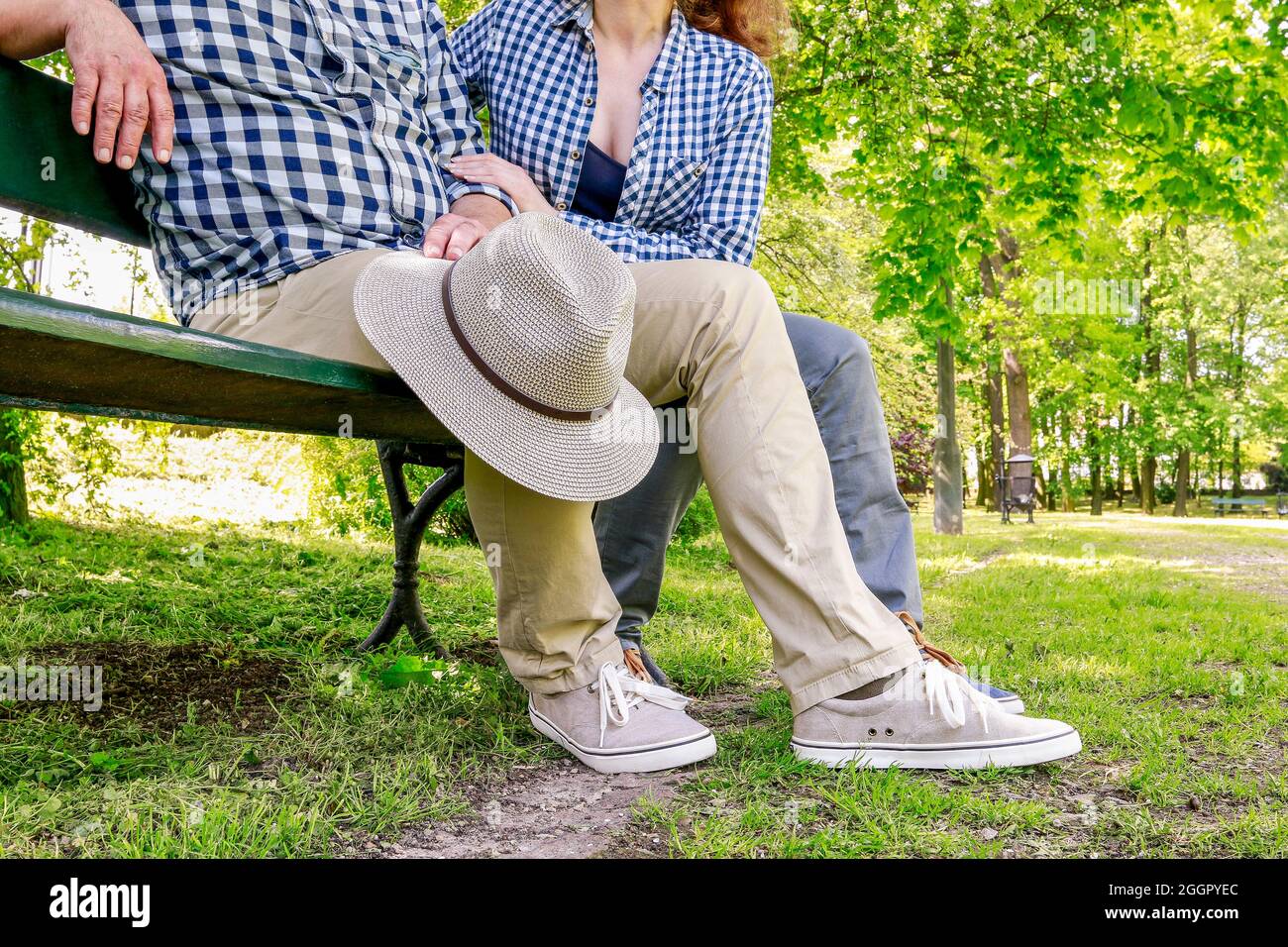 Man and woman sitting on the bench in beautiful summer park Stock Photo ...