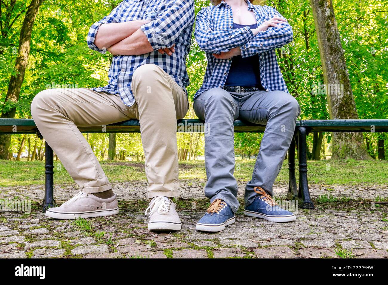 Angry couple sitting on the bench in beautiful summer park. Stock Photo