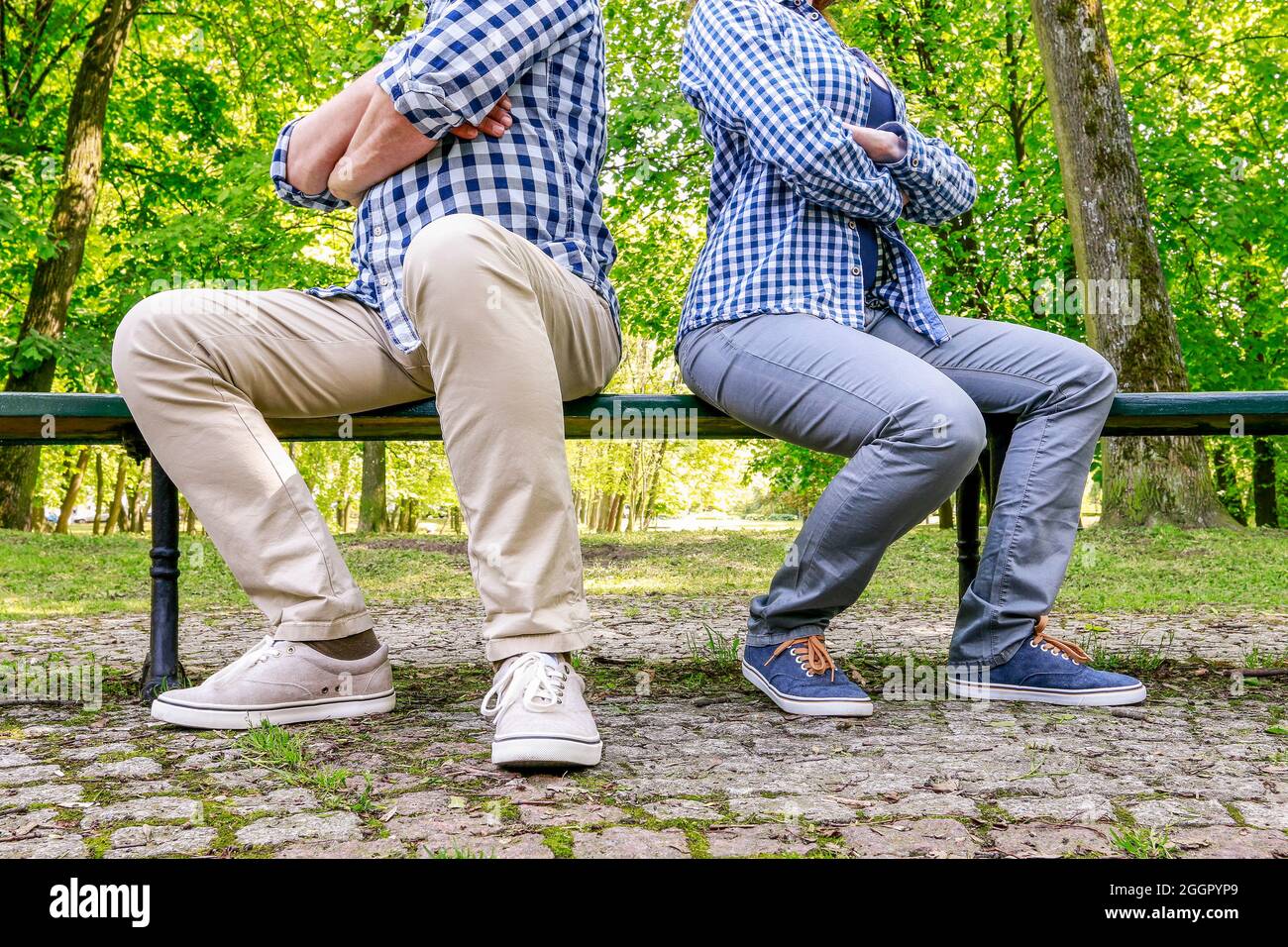 Angry couple sitting on the bench in beautiful summer park Stock Photo ...