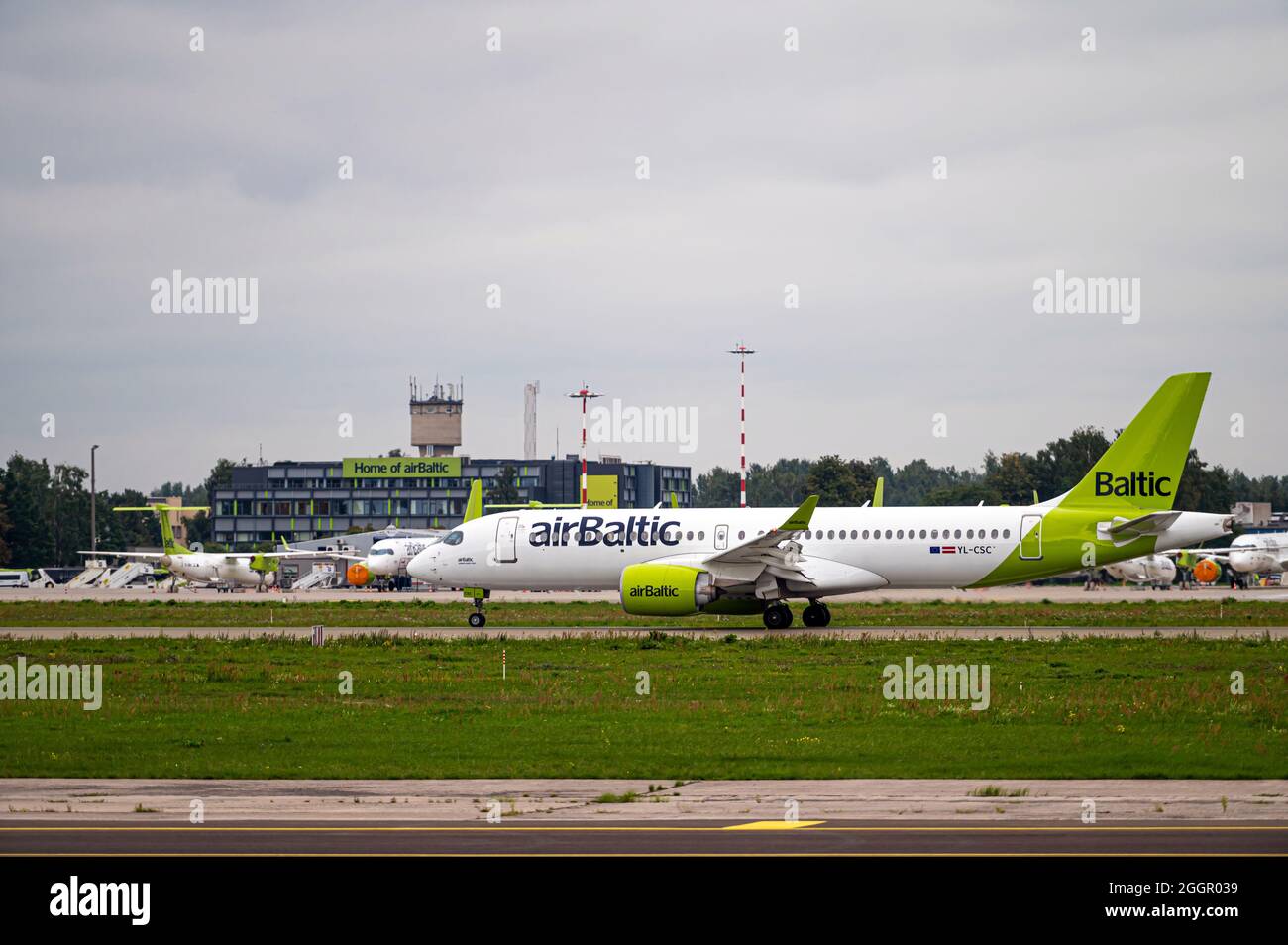 Riga, Latvia - August 31, 2021: AirBaltic Airbus A220-300 YL-AAS landing/arrival in Riga/RIX/EVRA airport on cloudy autumn day Stock Photo