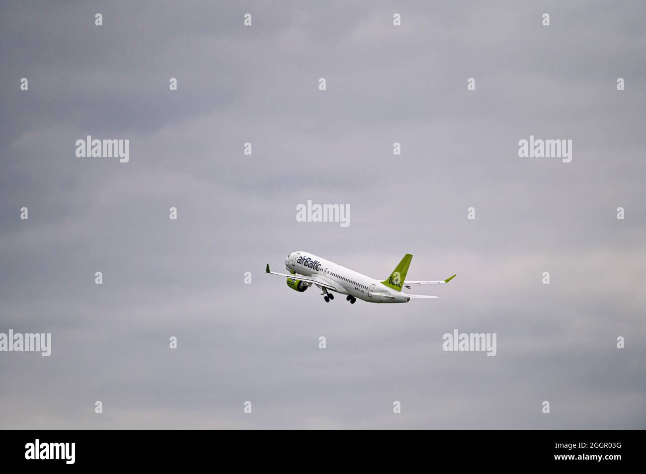 Riga, Latvia - August 31, 2021: AirBaltic Airbus A220-300 YL-AAS takes off from RIX International Airport on cloudy autumn day Stock Photo