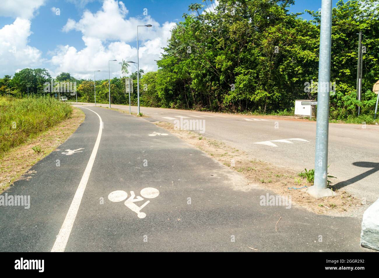 Road with bicycle lane in Saint-Georges town, French Guiana Stock Photo