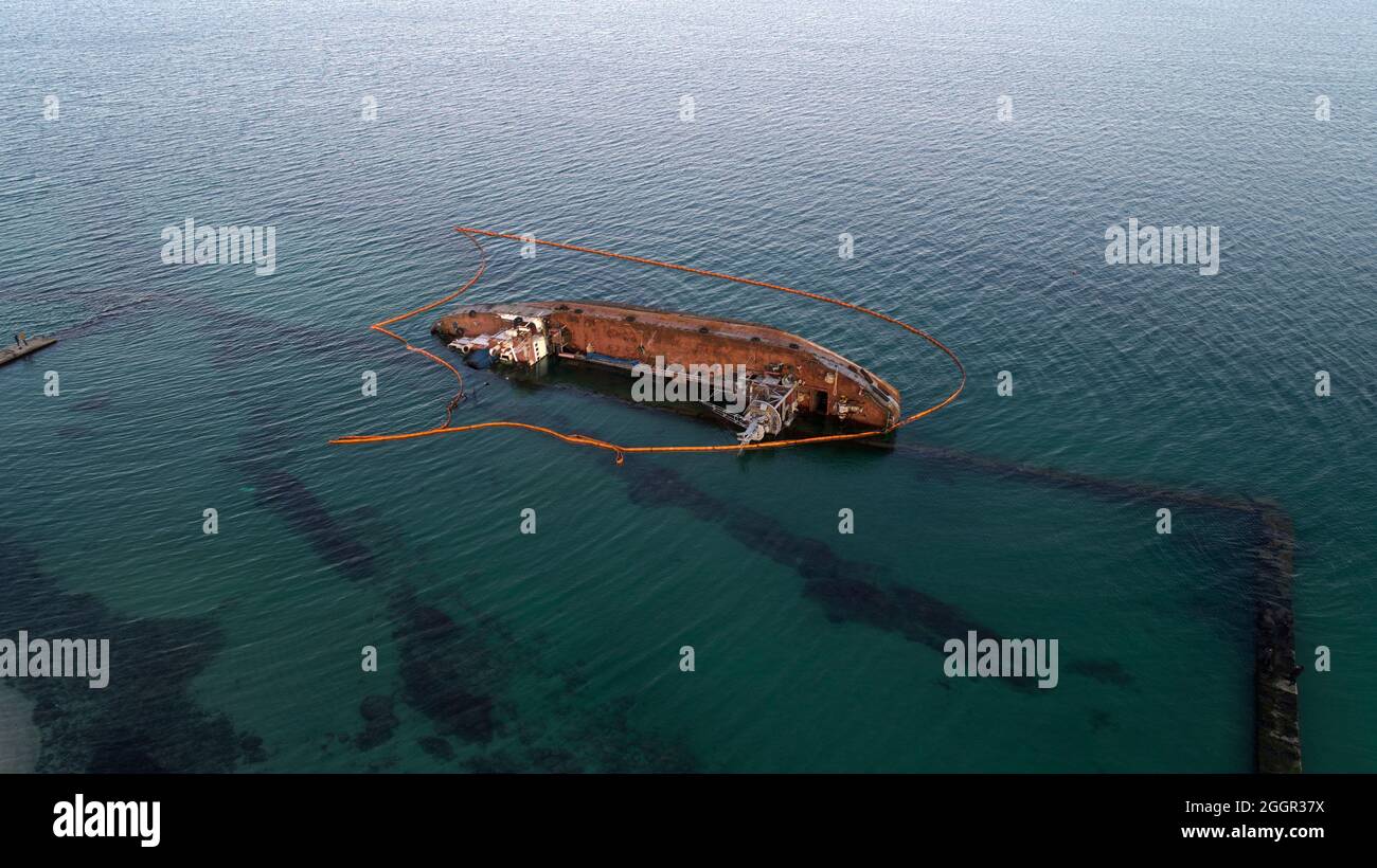 sunken tanker. Tanker Bunker threw storm ashore. The tanker lies on its side. Accident with tanker Stock Photo