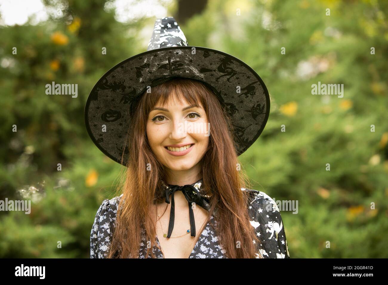 Halloween. Beautiful young woman in a festive mood at a Halloween picnic. Warm autumn October day. Emotion concept. Stock Photo