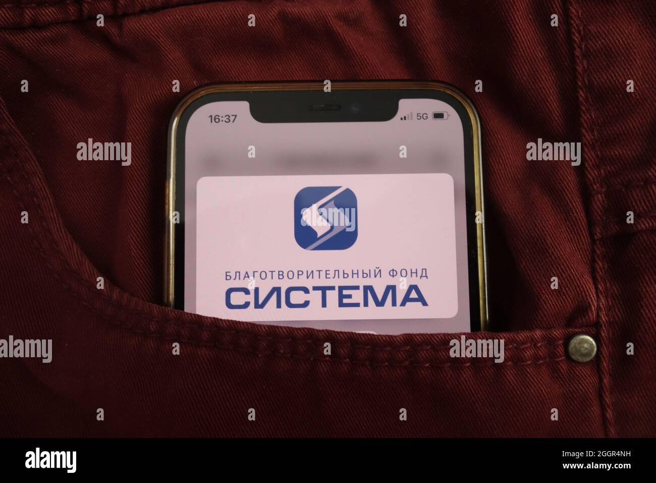 KONSKIE, POLAND - August 17, 2021: AFK Sistema PAO logo displayed on mobile phone hidden in jeans pocket Stock Photo