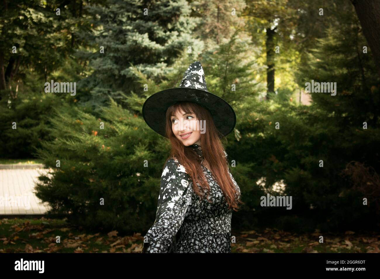 Halloween. Beautiful young woman in a festive mood at a Halloween picnic. Warm autumn October day. Emotion concept. Stock Photo