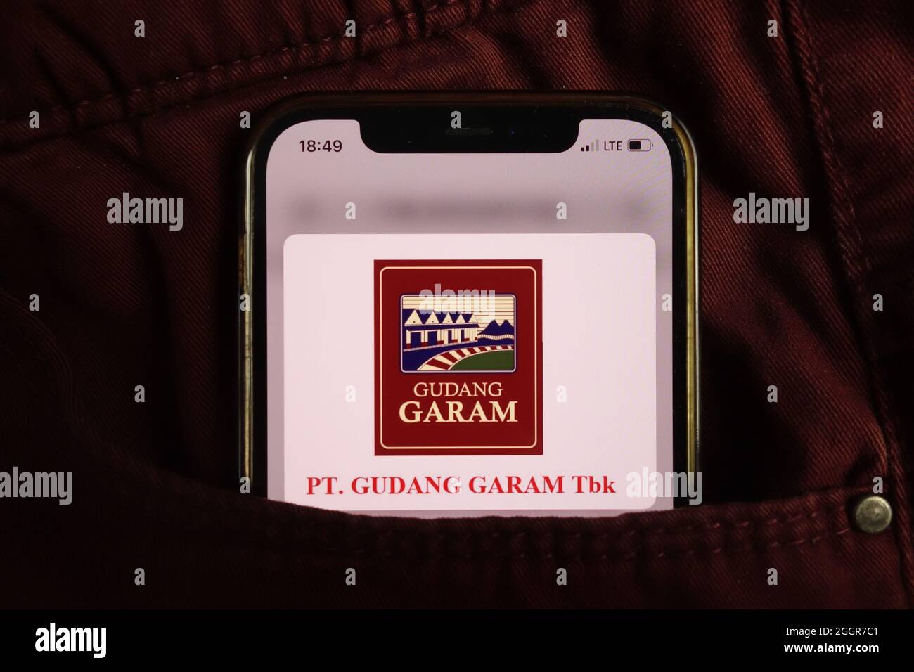 KONSKIE, POLAND - August 17, 2021: PT Gudang Garam Tbk logo displayed on mobile phone hidden in jeans pocket Stock Photo