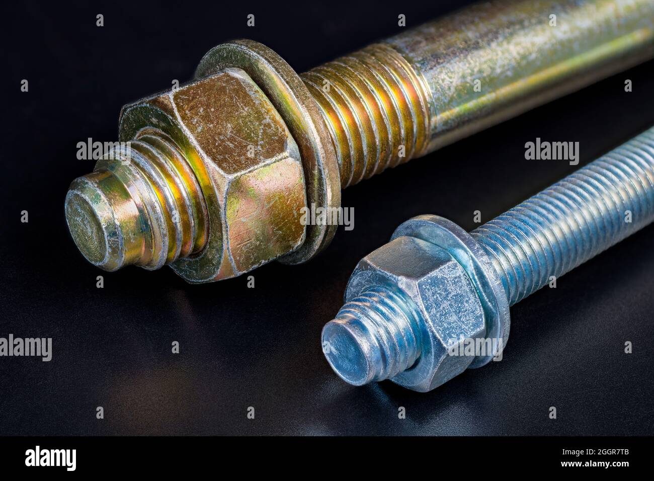 Metal nuts and washers on galvanized bolts detail with reflection on a