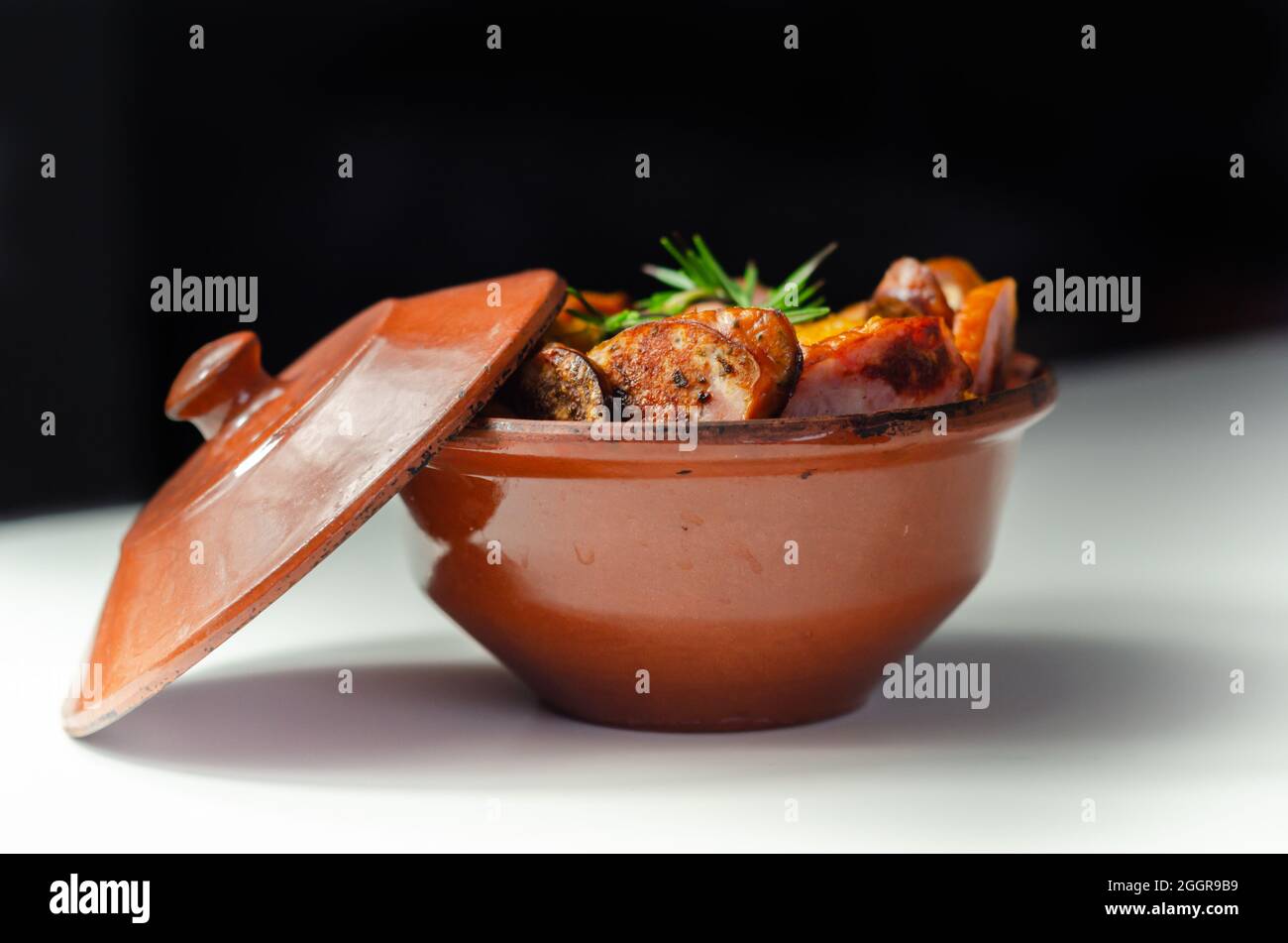 Traditional Polish dish called bigos made of sauerkraut, sausage and mushrooms, food served warm in a ceramic bowl, Eastern European food Stock Photo