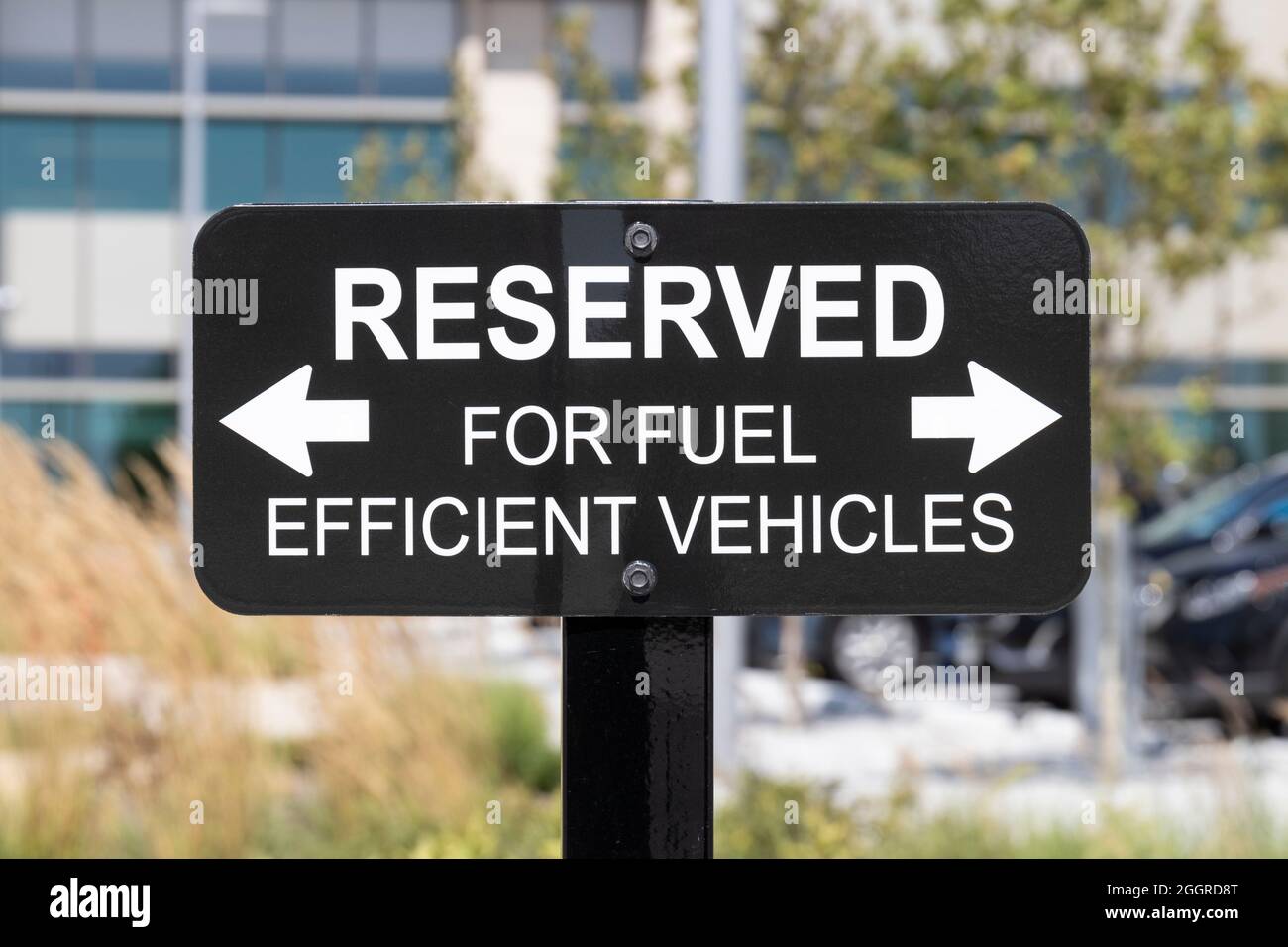 RESERVED For Fuel Efficient vehicles sign. Parking is reserved for electric, EV and hybrid