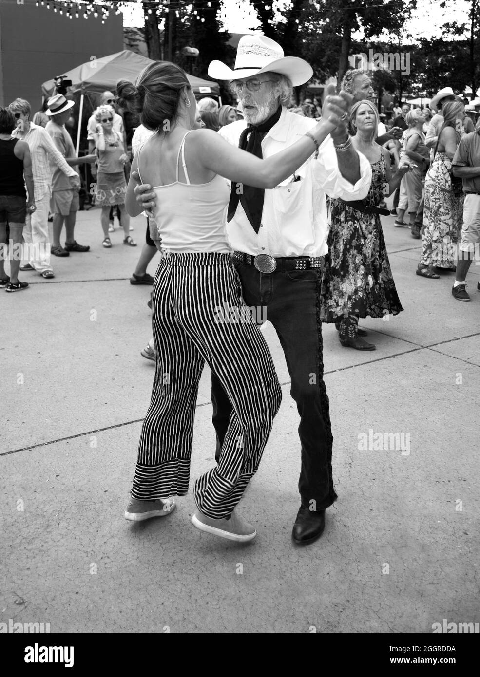 Couples dance at an outdoor music concert in the historic Plaza in Santa Fe, New Mexico. Stock Photo