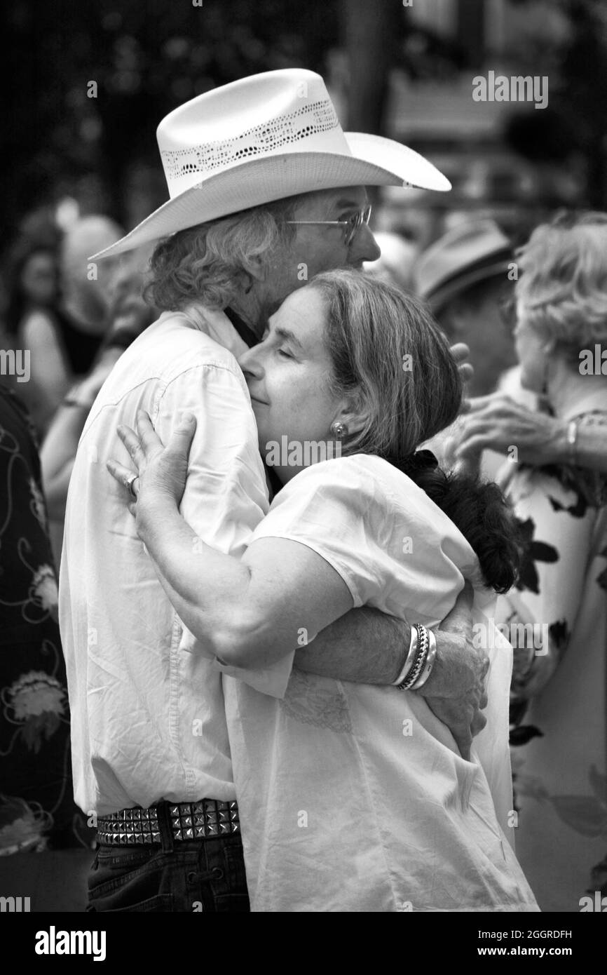 Couples dance at an outdoor music concert in the historic Plaza in Santa Fe, New Mexico. Stock Photo