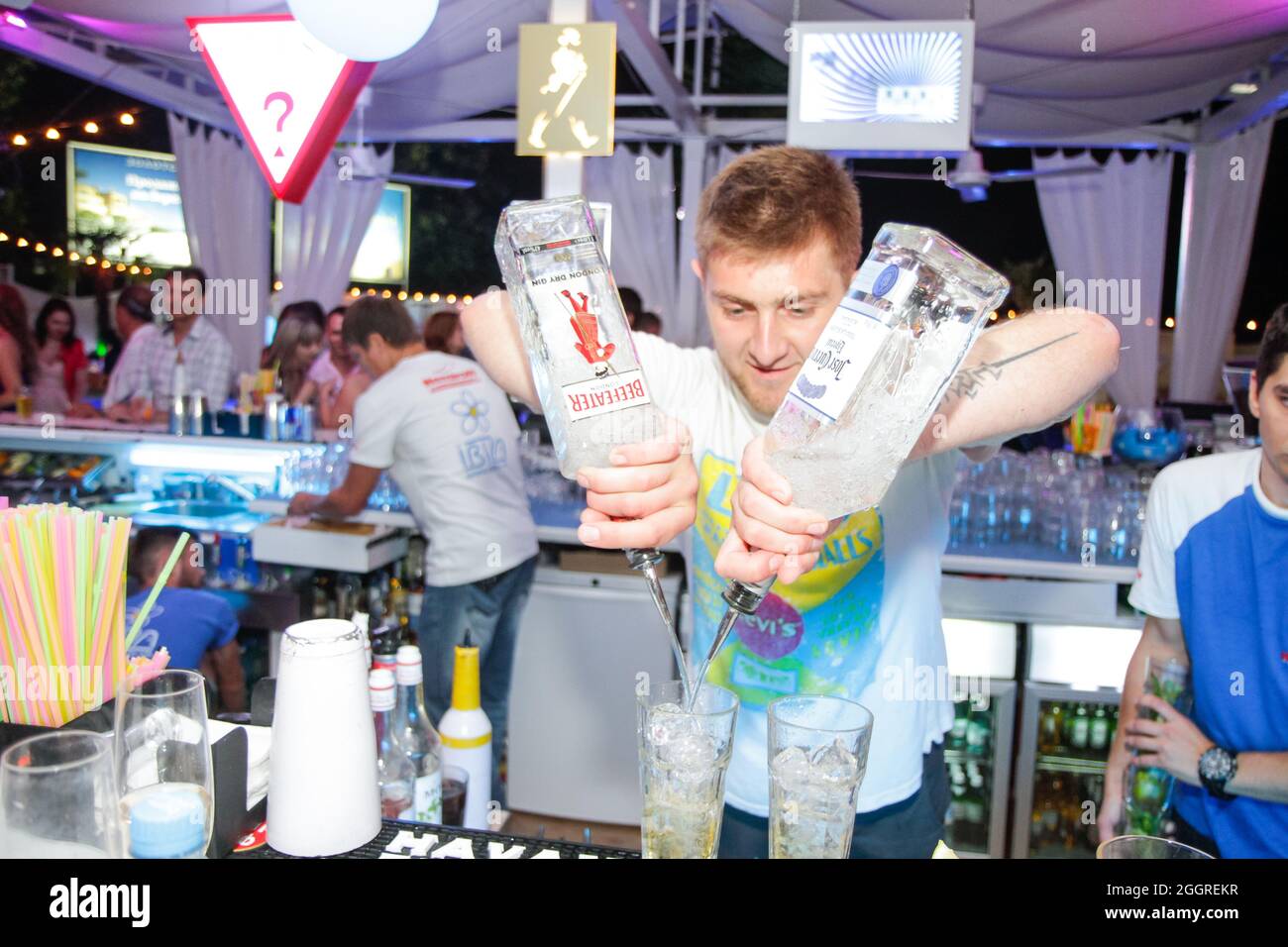 Odessa, Ukraine May 24, 2013: Barman at work in luxury nightclub during night party. Bartender make fun at party time in elite night club Stock Photo