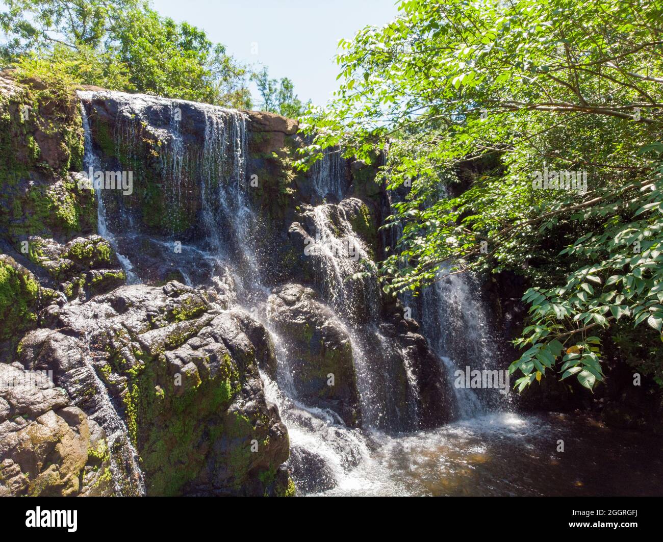 Shot of a beautiful waterfall streaming through the rocks Stock Photo ...