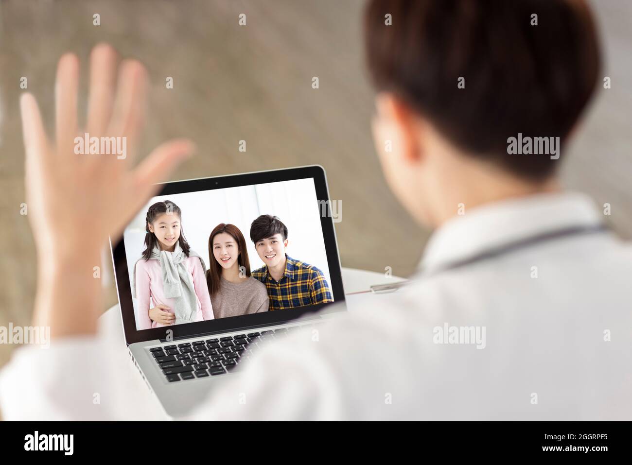 Man having video chat with friends and family using laptop.Family meet their doctor by video call. Stock Photo