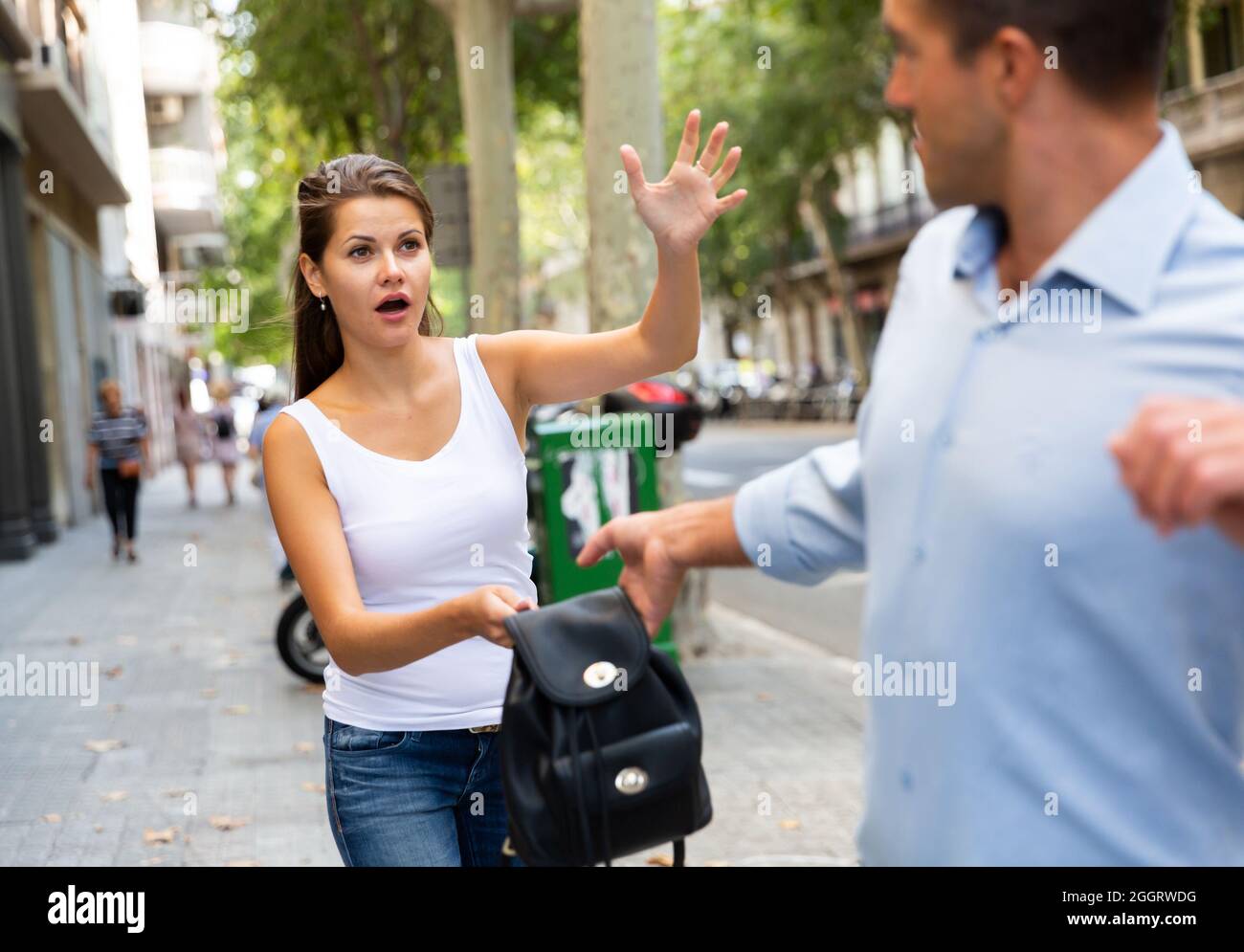 Thief stealing from handbag of a woman in a store Stock Photo - Alamy