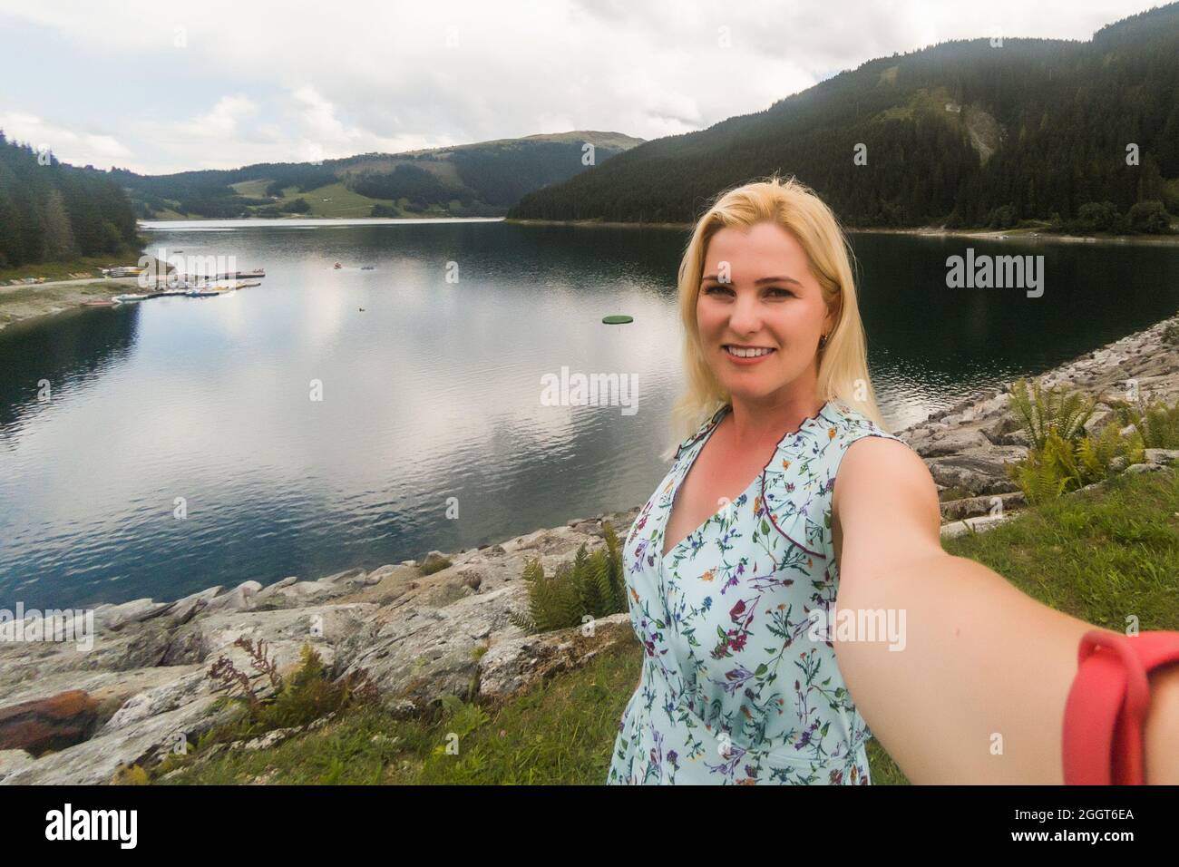 Rear view of a female hiker walking on a trail in the Alps near Ehrwald ...