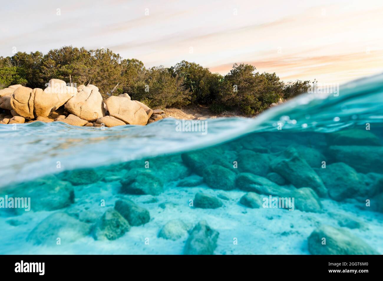 Selective focus) Split-shot, over-under shot. Half underwater half sky with  turquoise sea and a rocky coastline illuminated at sunset Stock Photo -  Alamy