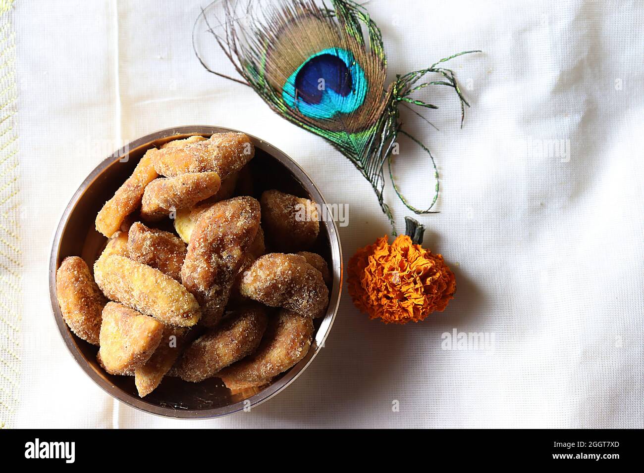 Sharkara Varatti/upperi/jaggery coated banana chips in brass uruli/Kerala/Onam festival Stock Photo