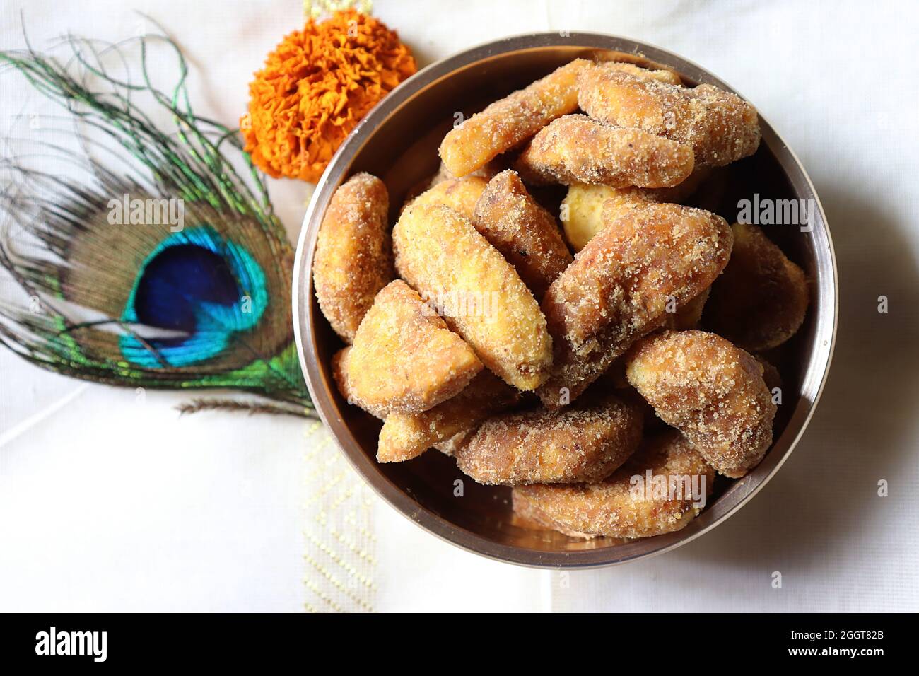 Sharkara Varatti/upperi/jaggery coated banana chips in brass uruli/Kerala/Onam festival Stock Photo
