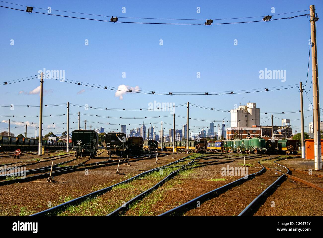 Freight trains in the rail yard with Melbourne skyline in the