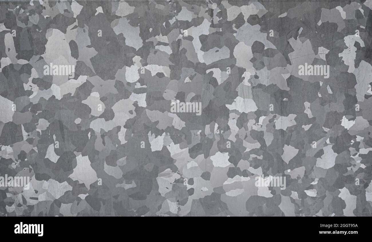 Close-up of scratched gray galvanized zinc plate. Abstract full frame textured background in black and white. Copy space. Stock Photo