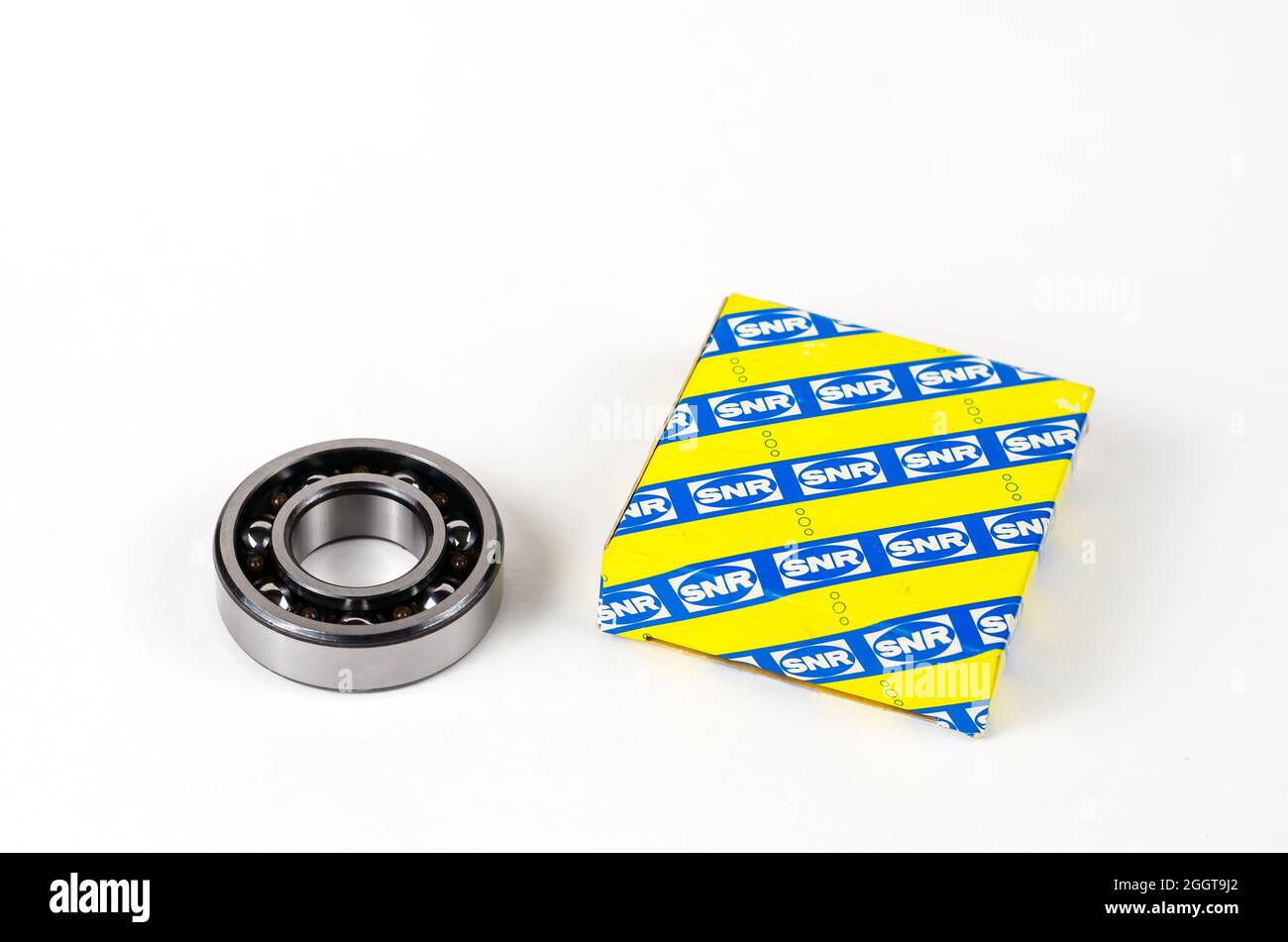 New ball bearing and square paper box on white background. Auto Stock Photo