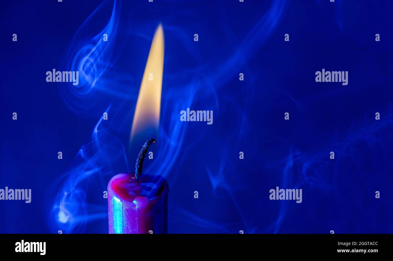 Candle with smoke and flame as a background with structure and copy