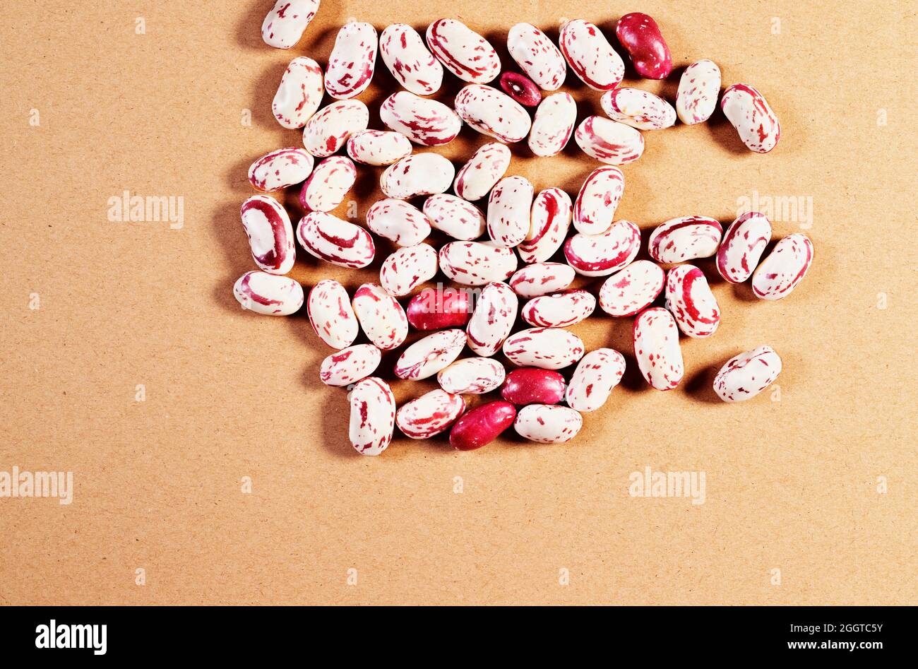 Fresh borlotti beans on brown background , beans with red specks on