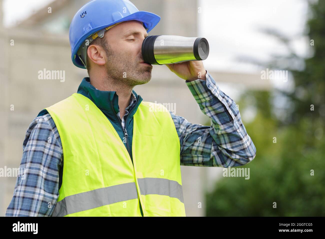 engineer builder having a coffee break at construction site Stock Photo ...