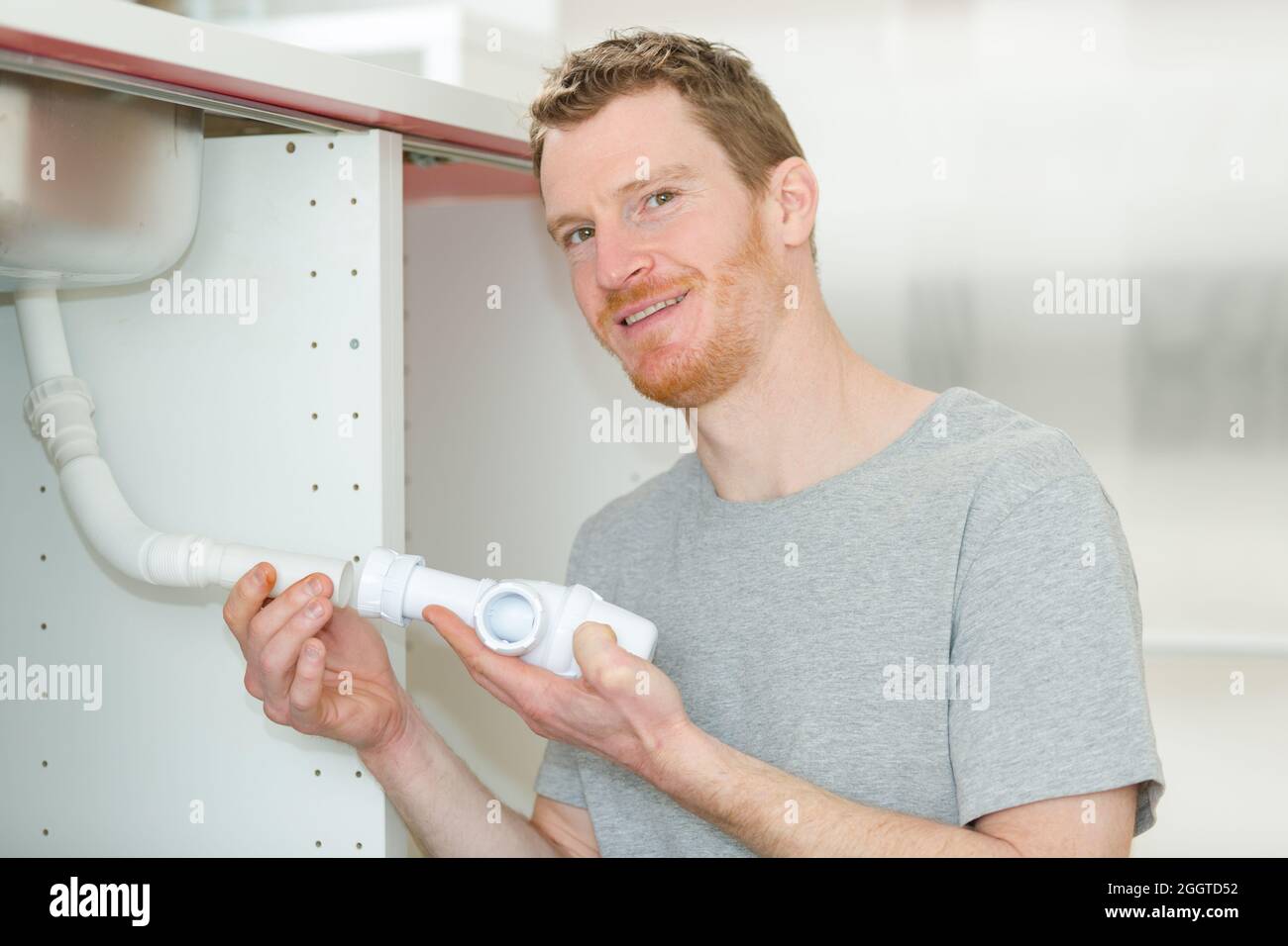 man removing drain pipe under the sink Stock Photo Alamy
