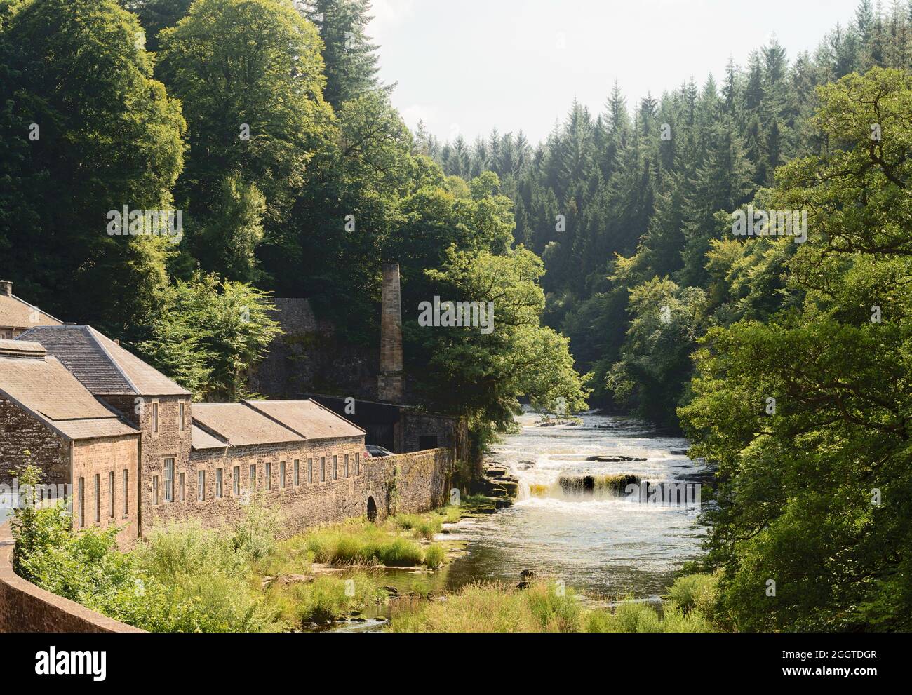 The river Clyde passes over a waterfall in New Lanark, Scotland, UK Stock Photo