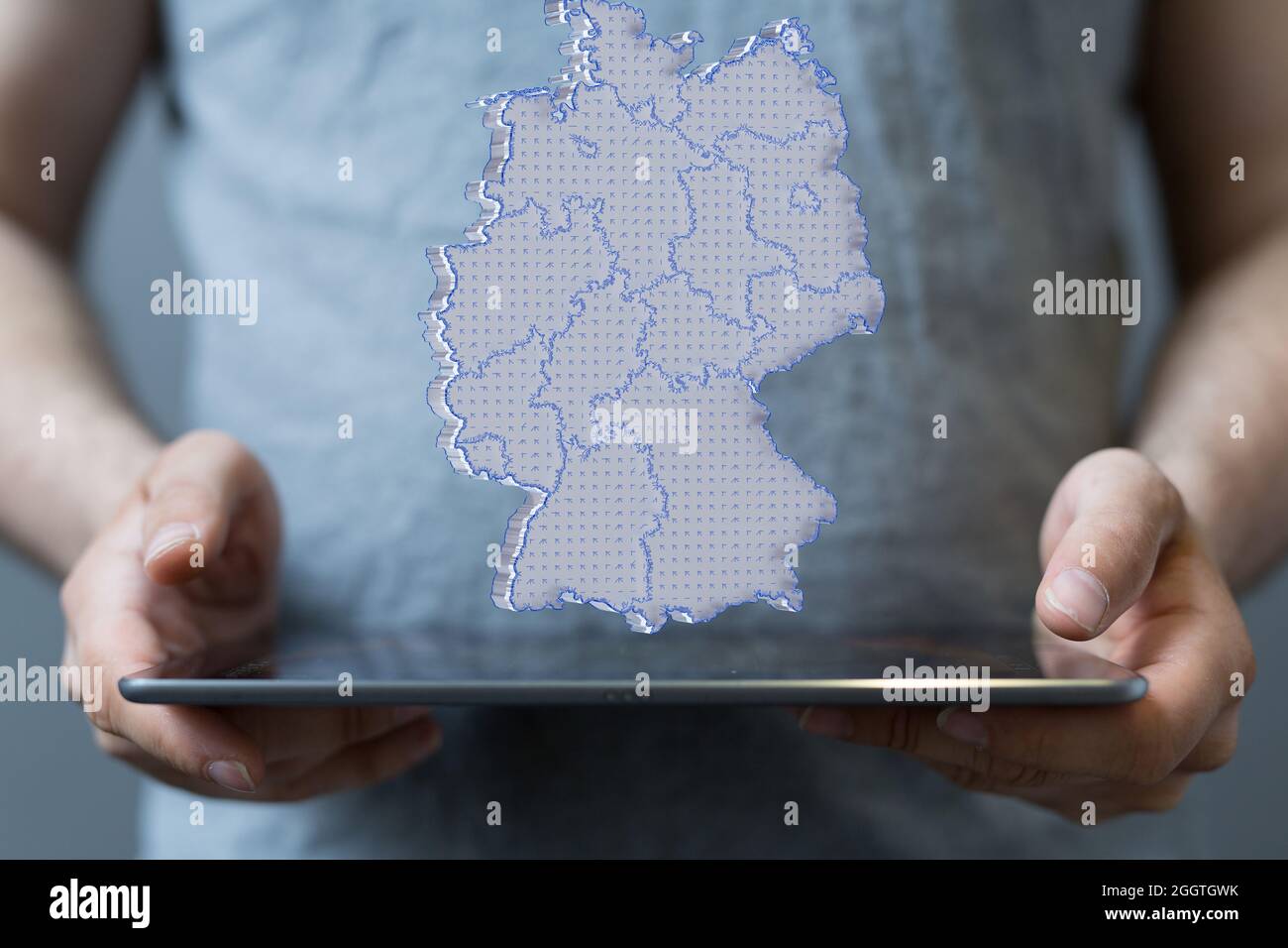 Person presenting a 3D render of the map of Germany Stock Photo - Alamy