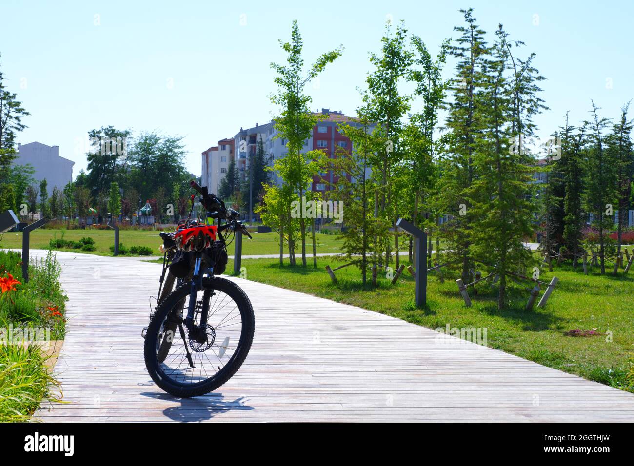 Bike Parked at City Park with Helmet and Accessories on it Stock Photo