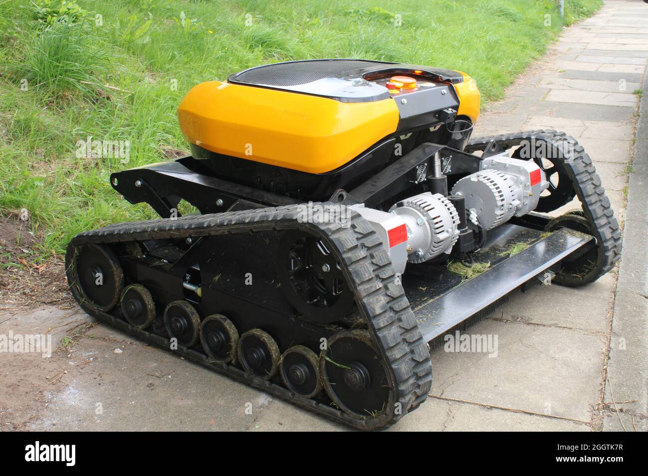 Robotic caterpillar tracked industrial lawnmower and bush cutter Stock Photo