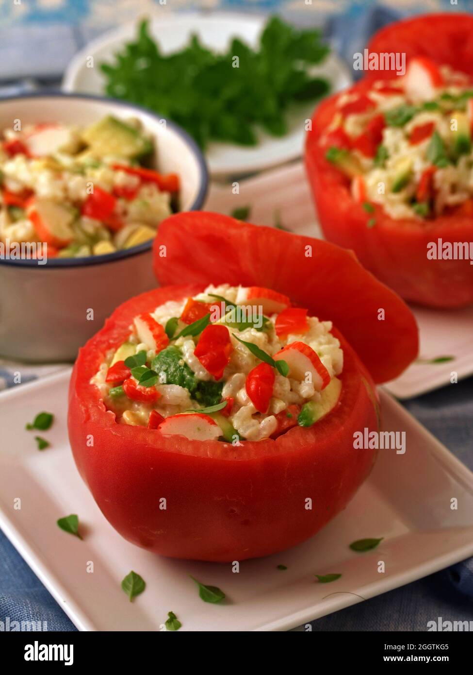 Filled tomatoes with rice, surimi and veggies. Stock Photo