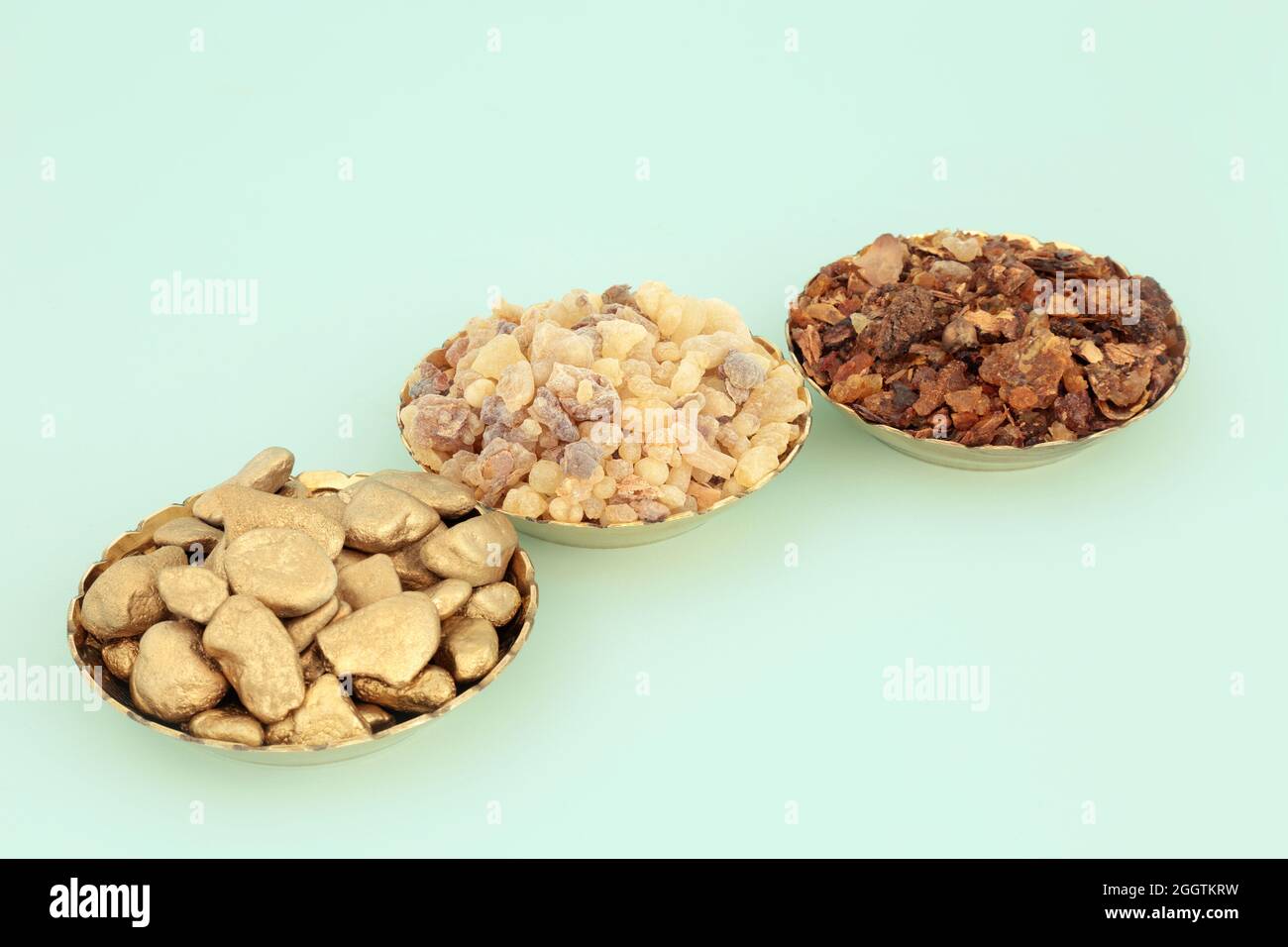 Gold frankincense and myrrh in bowls. Symbols of gifts in Christian
