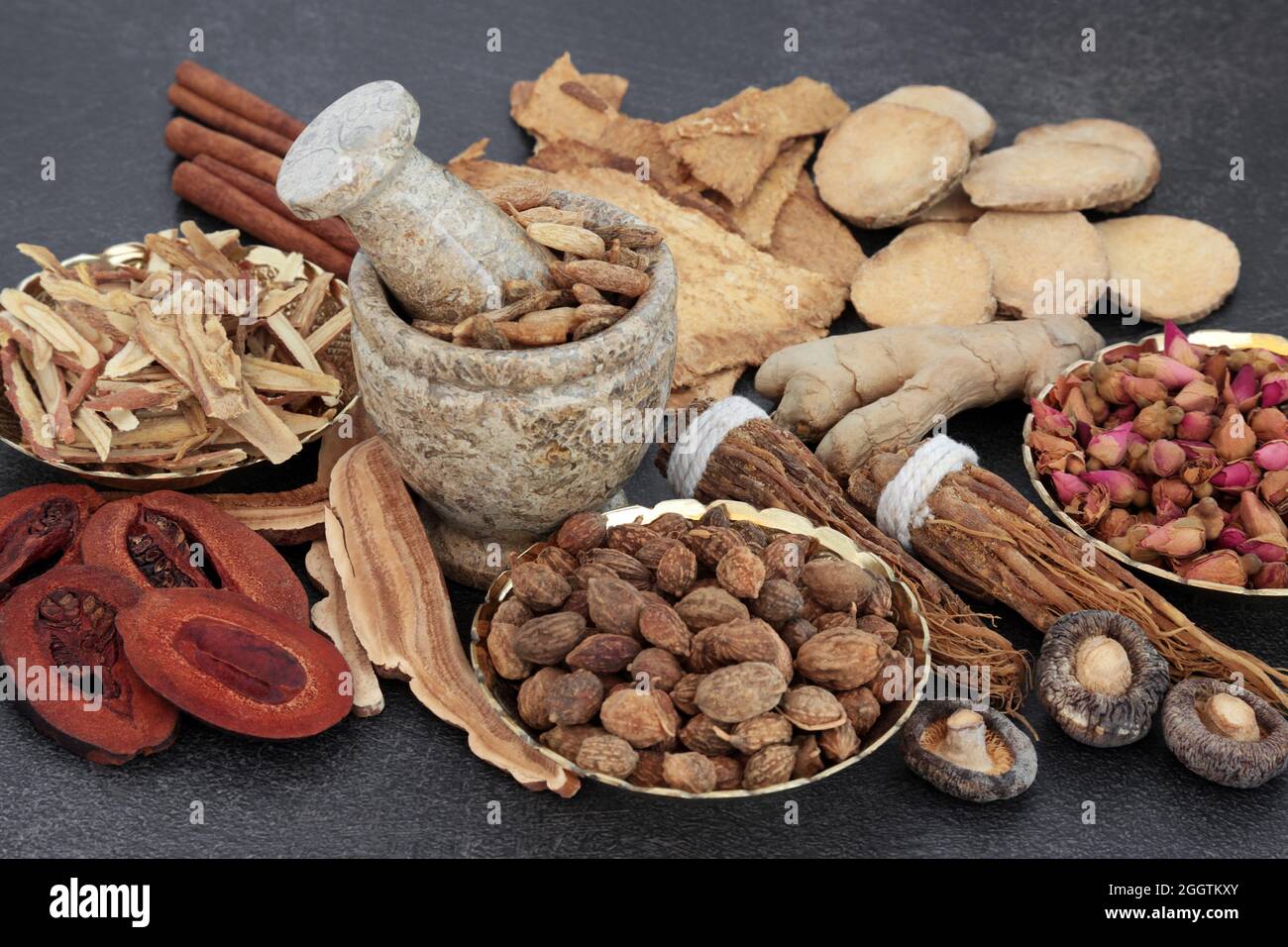 Chinese plant based herbal medicine with a collection of herbs and spice on slate background used in traditional natural healing remedies. Stock Photo