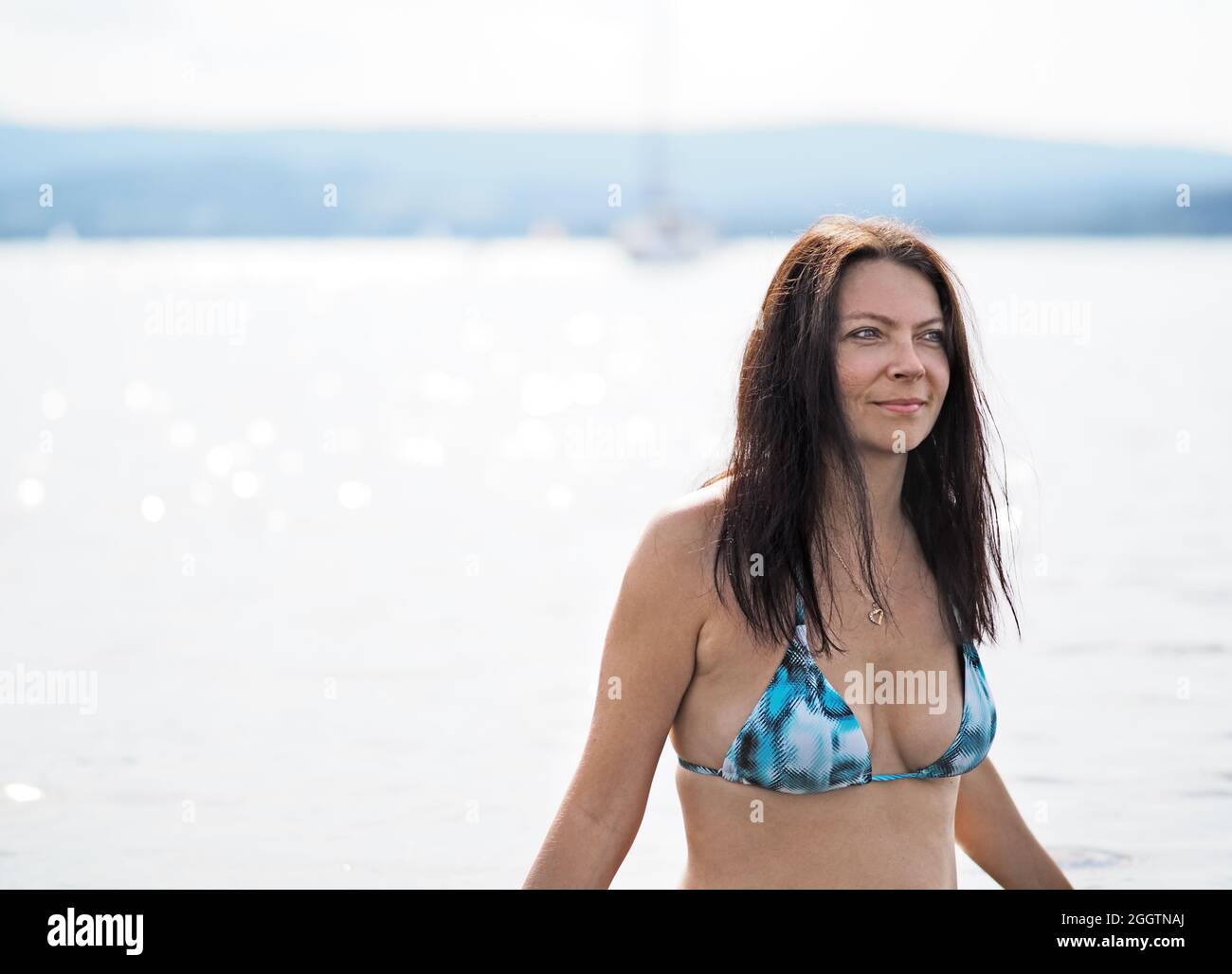 Young woman swims in the lake Stock Photo