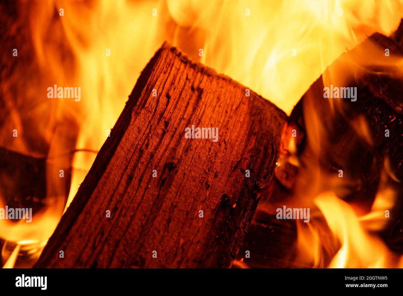Wood is burning well in an open fireplace Stock Photo