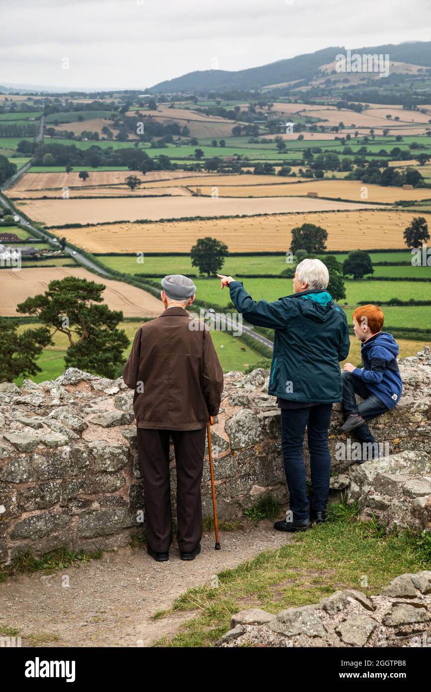 Visitors to Montgomery Castle admire the view from the ramparts, Montgomery, Powys, Wales Stock Photo