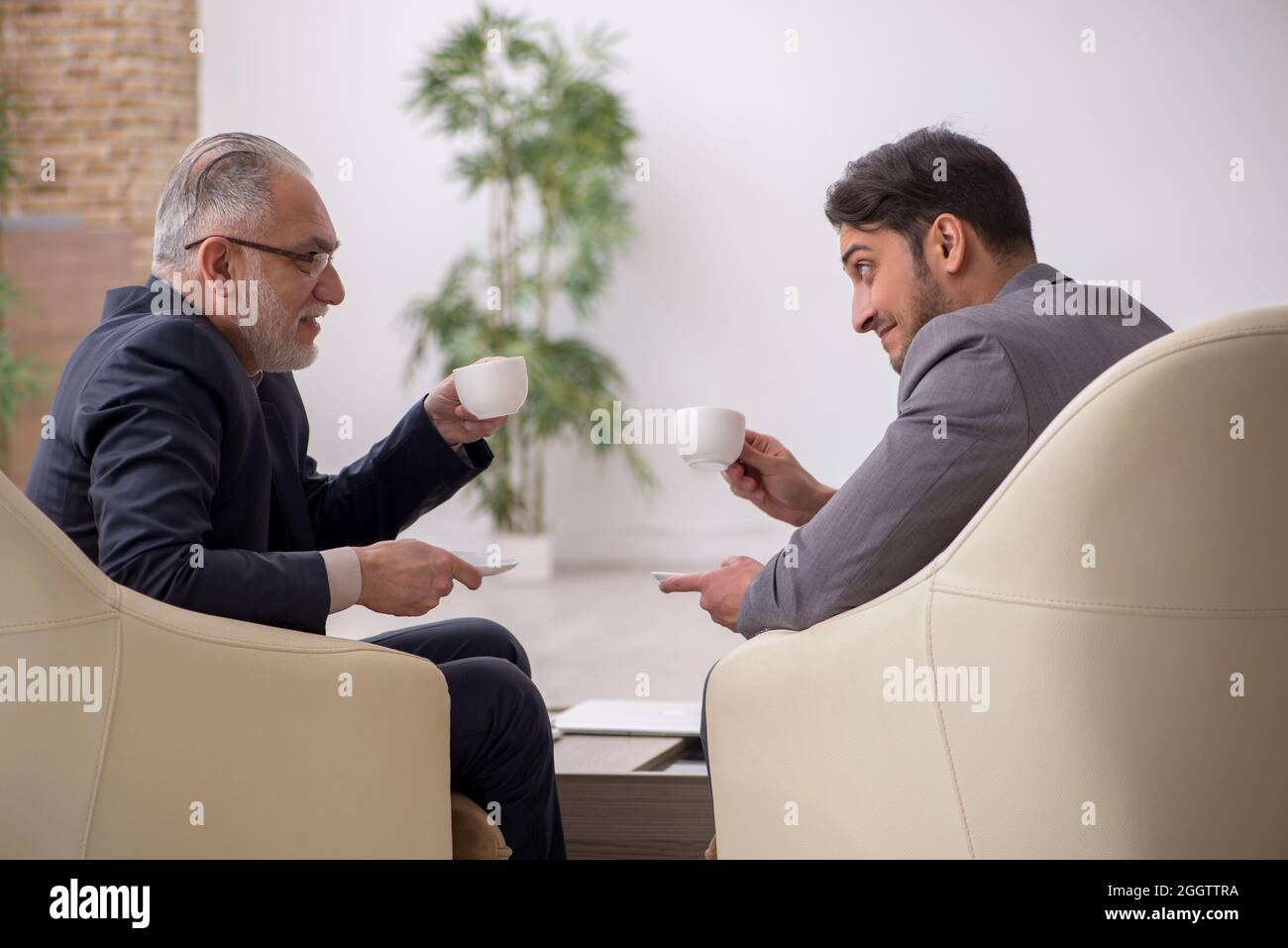 Two businessmen discussing project in the office Stock Photo