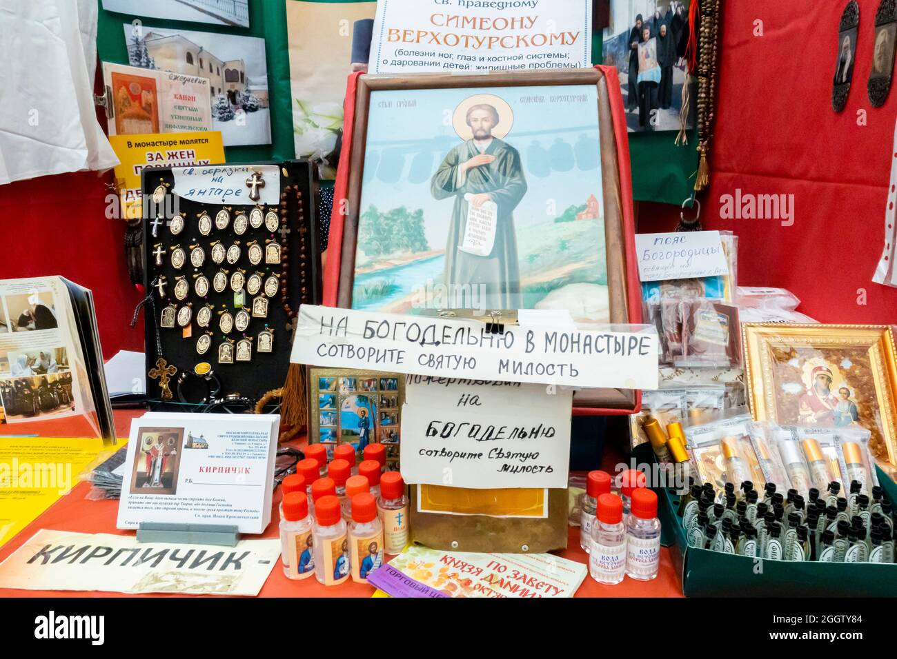 Stand selling religious paraphernalia and signs asking for donations at stand Orthodox fair, Moscow, Russia Stock Photo