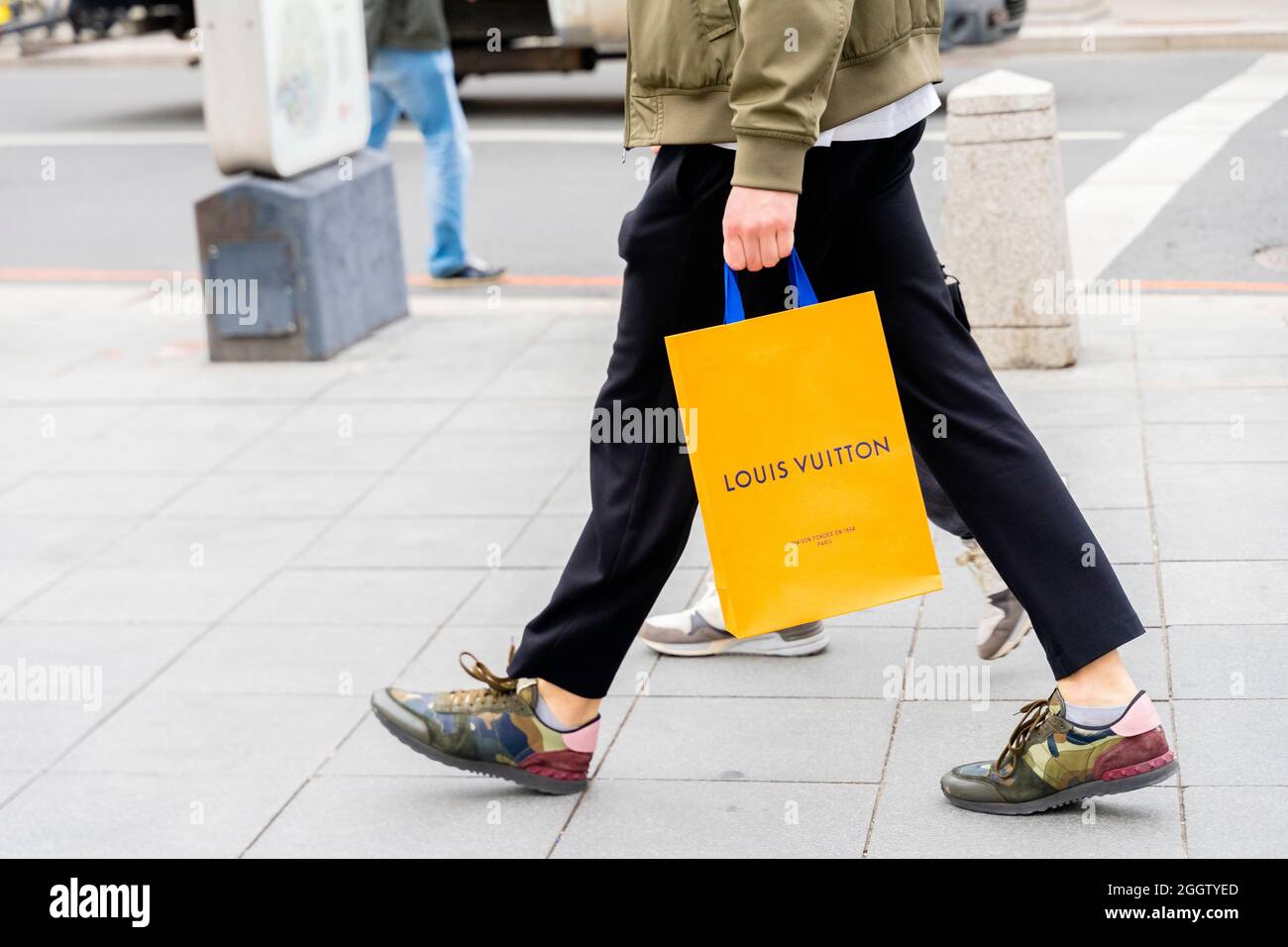 A man carrying a Louis Vuitton bag while walking, Moscow, Russia. Concept-consumerism, consumer economy, consumer spending. Stock Photo