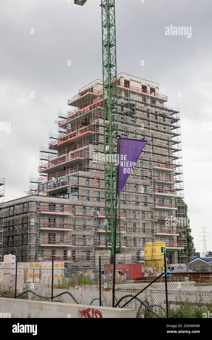 New building of apartments at the old docks of Ghent leaving the cranes as monuments of the past