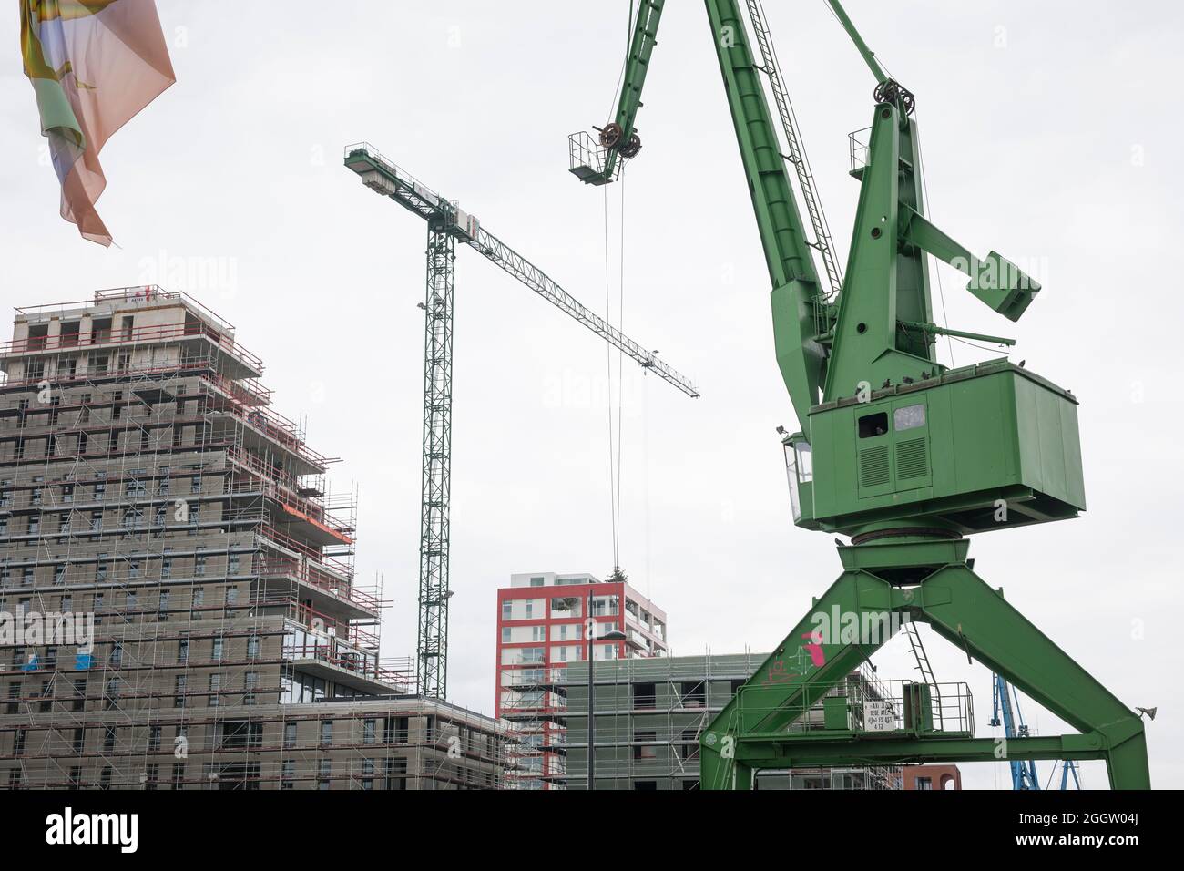 New building of apartments at the old docks of Ghent leaving the cranes as monuments of the past