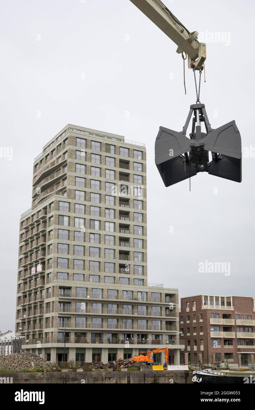 New building of apartments at the old docks of Ghent leaving the cranes as monuments of the past