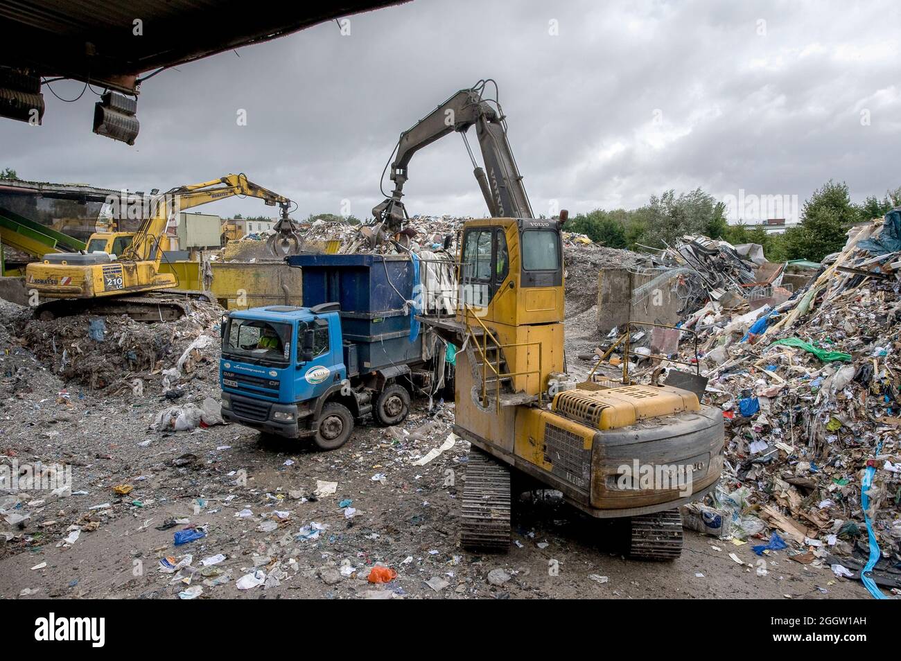 Volvo and Komatsu crawler excavators working at a materials recycling facility in the UK. Stock Photo